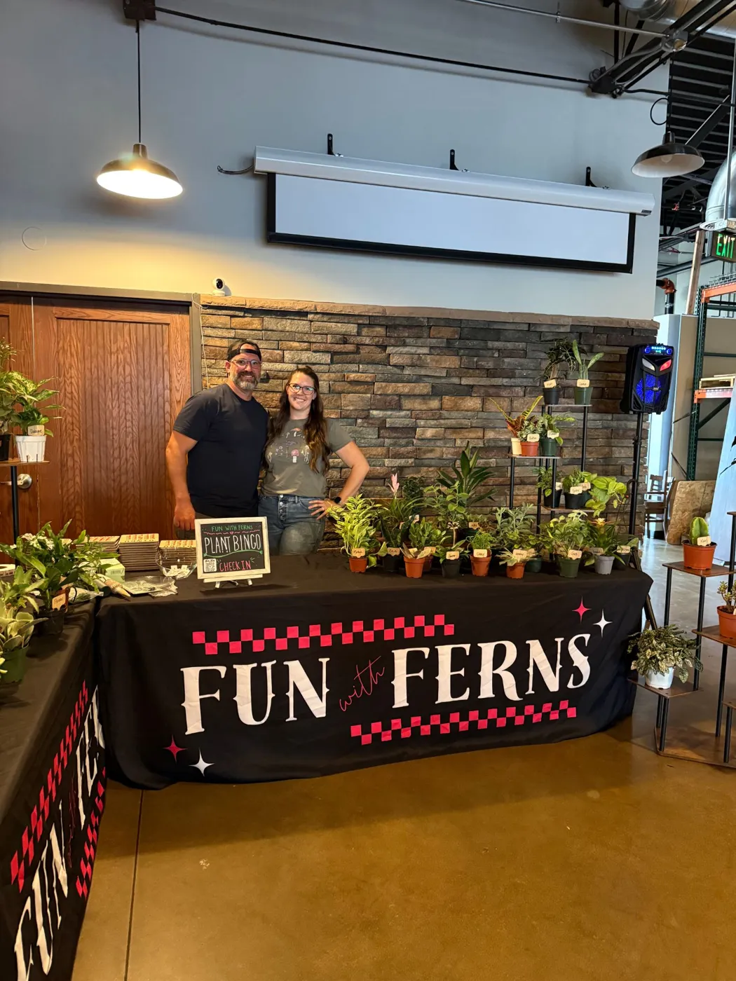 Alyssa and Michael with a full table of plant bingo prizes